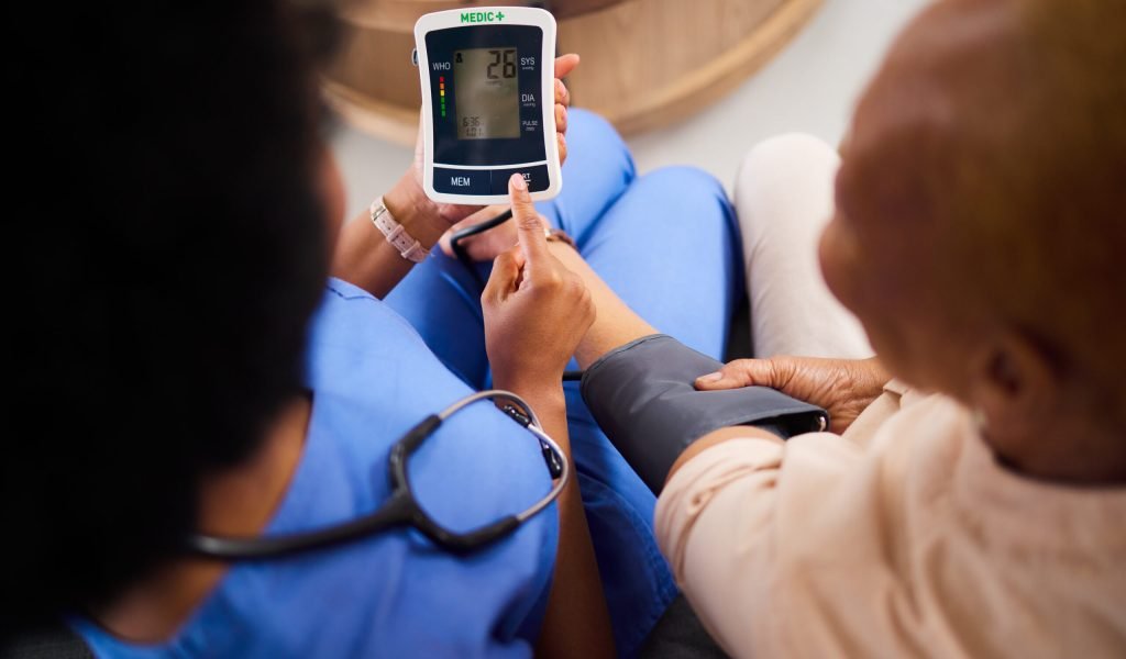 Doctor, machine or patient in test for blood pressure in a hospital for medical or healthcare exam