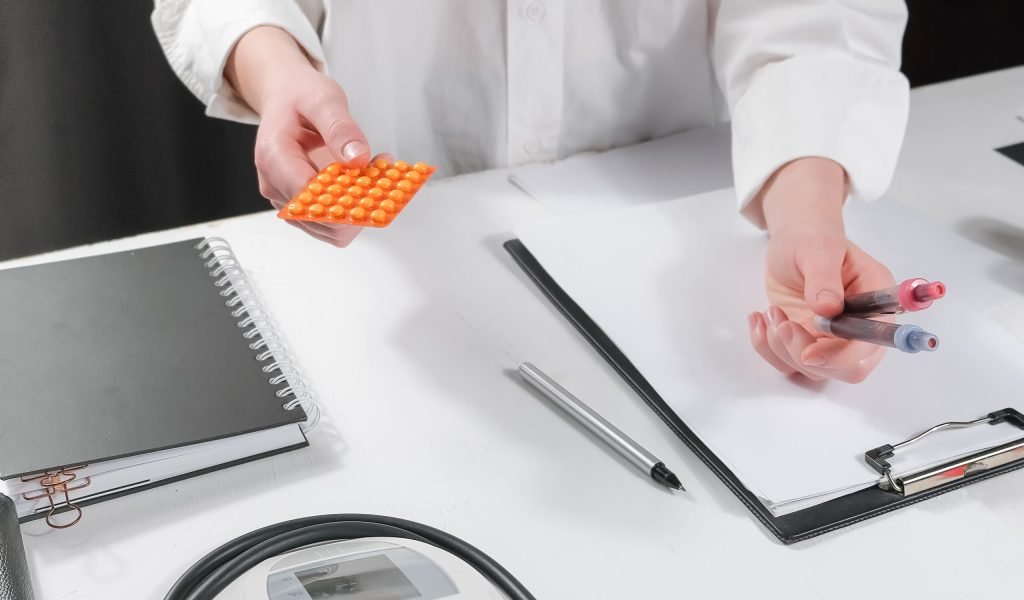 Medicine, doctor sitting at the table and writing a prescription to the patient, remote visit, online treatment, top view, medical background,