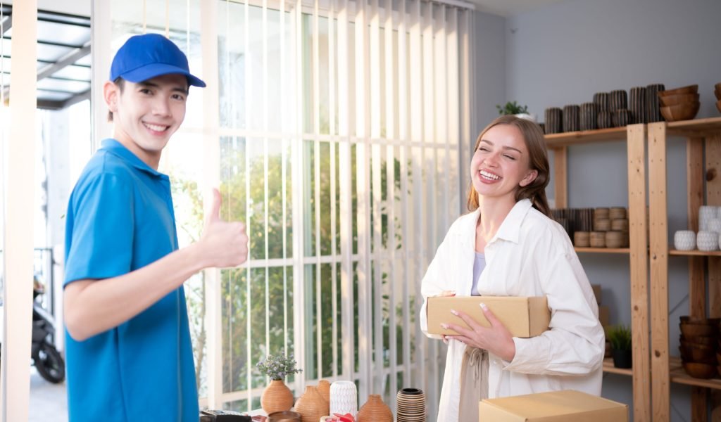 The delivery man brings the goods that the customer purchased and delivers them to the customer's home.